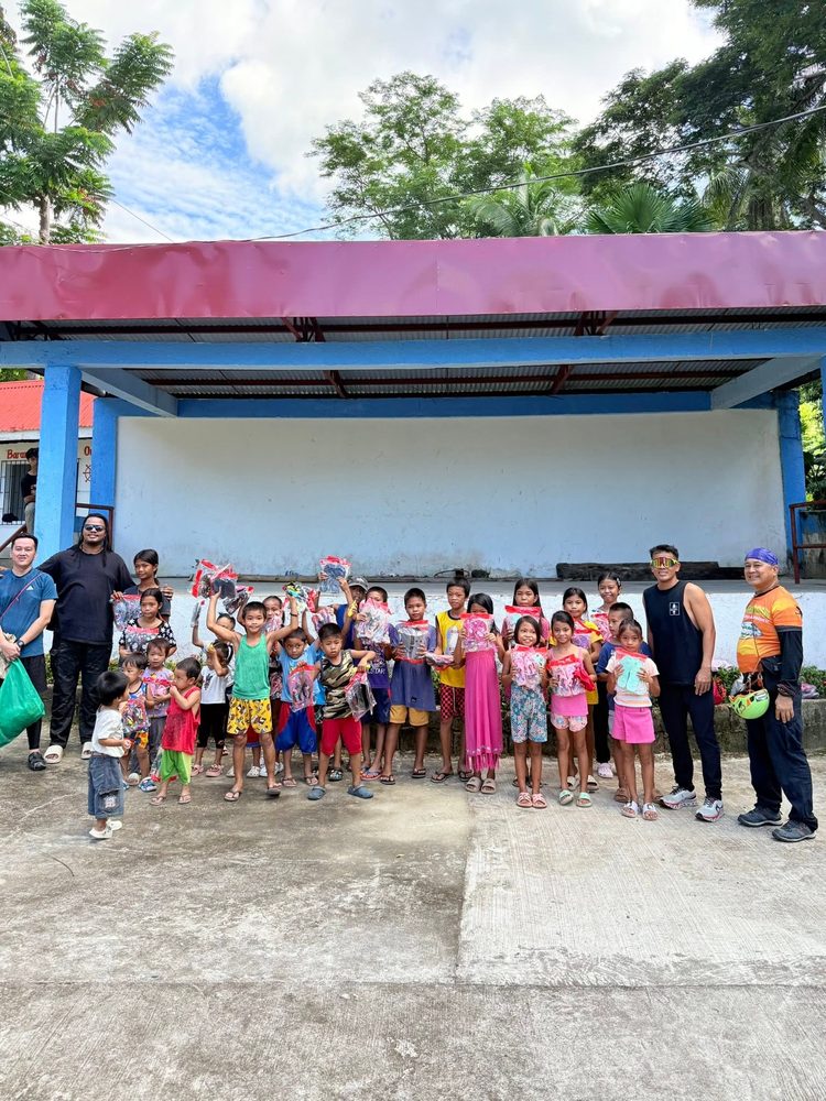 Papa Tantan Care team with children after a community donation drive